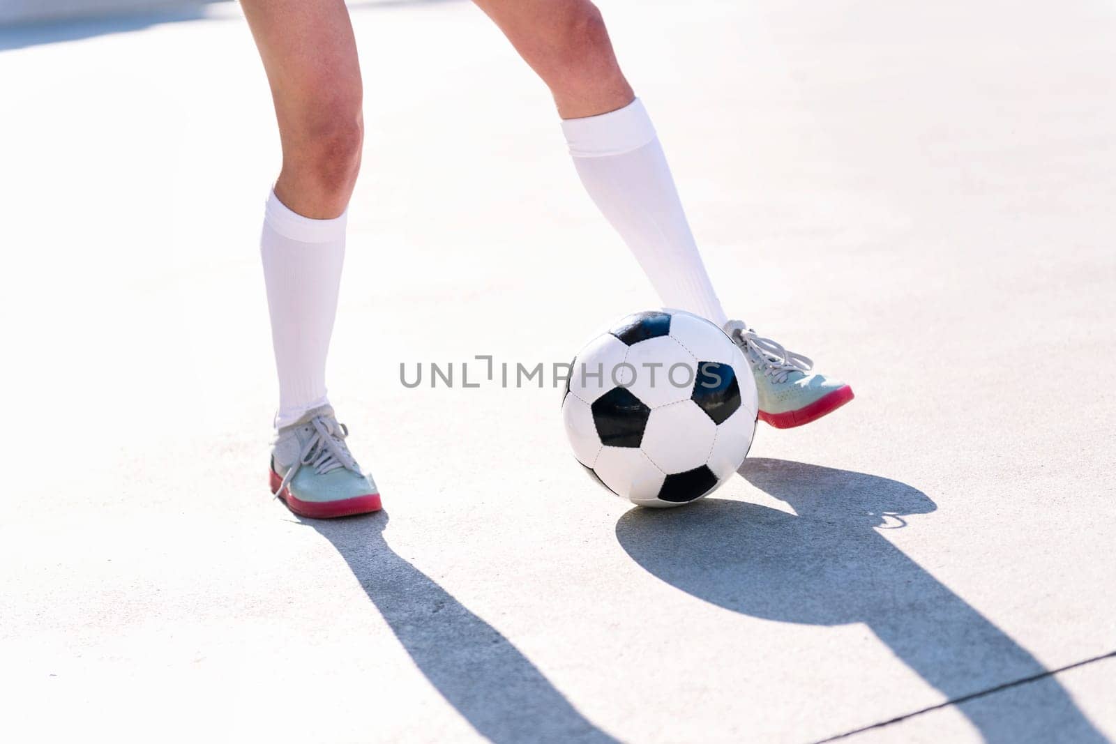 close up of the feet of a football player playing with a soccer ball, concept of sport and active lifestyle