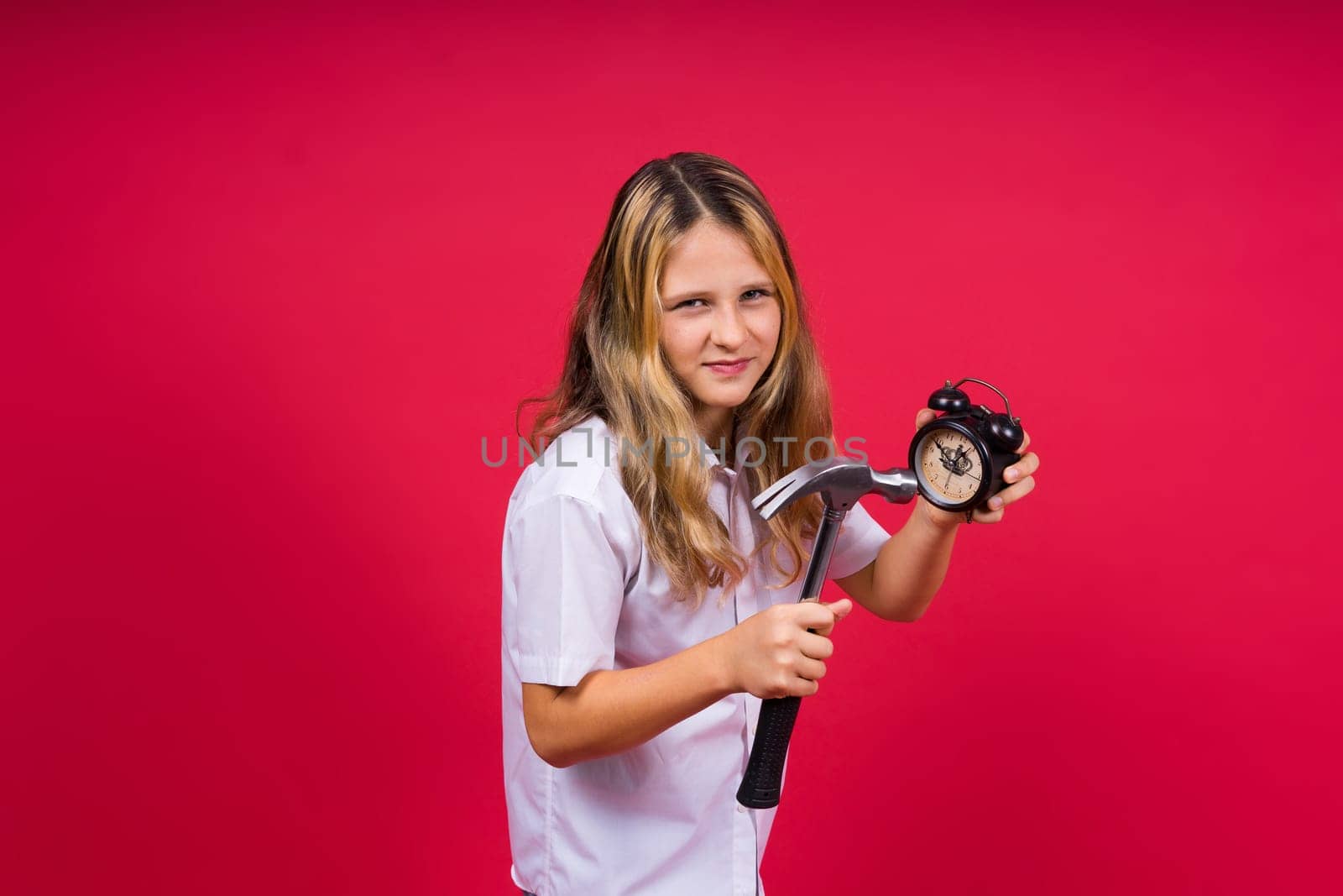 Teen girl 12, 13, 14 years old look at alarm clock. Good morning, checking time. Positive emotions. by Zelenin