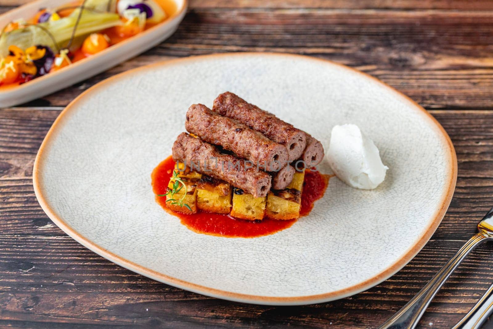 Antalya shish meatballs (sis kofte), a traditional Turkish delicacy, on wooden table by Sonat