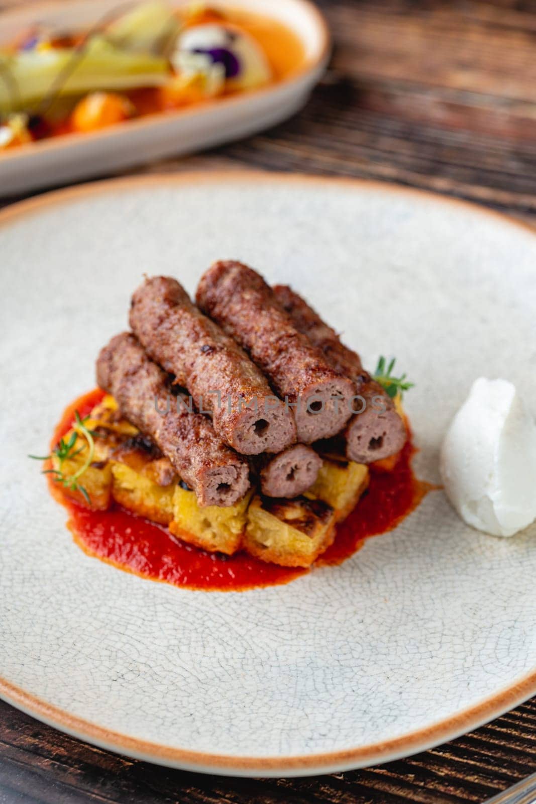 Antalya shish meatballs (sis kofte), a traditional Turkish delicacy, on wooden table by Sonat