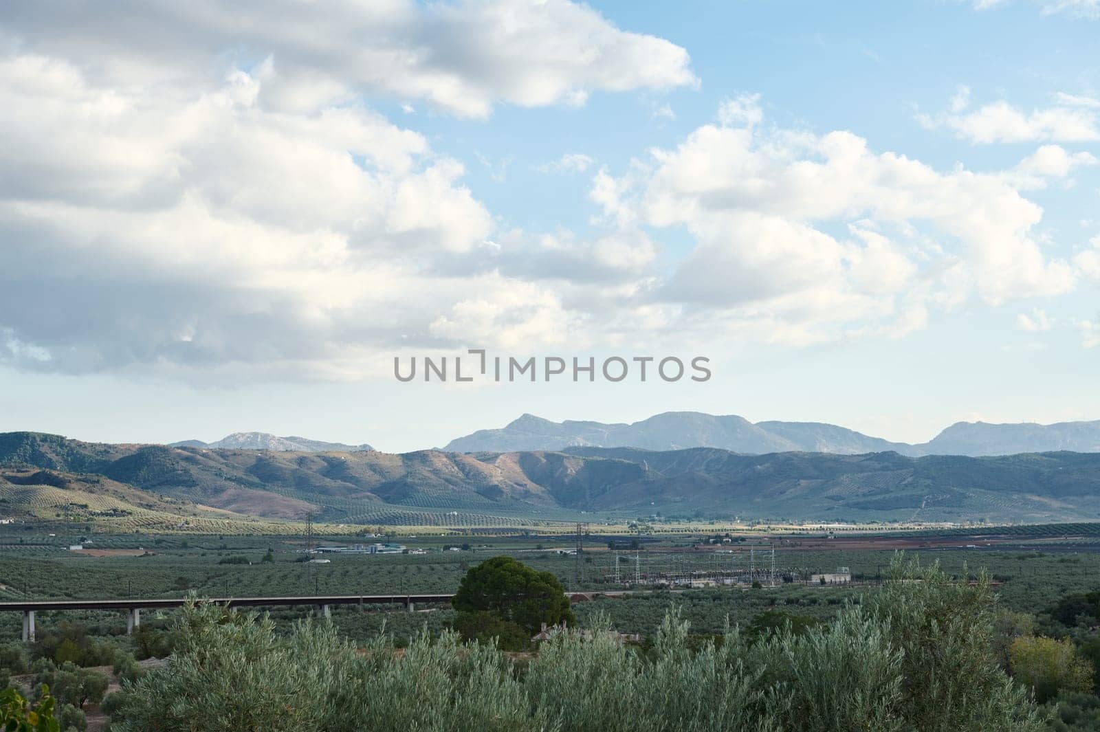 Scenic landscape of rolling mountains under a cloudy sky by artgf