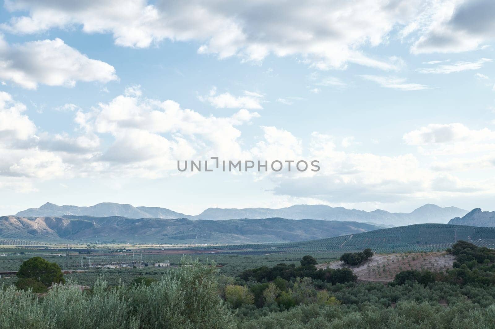 Scenic mountain landscape with cloudy sky in the distance by artgf