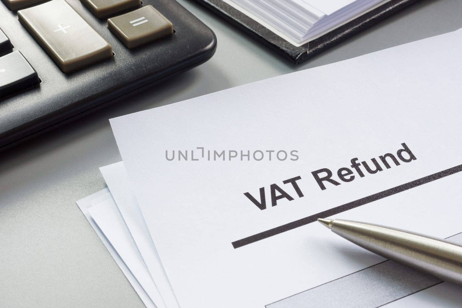 VAT refund form to fill out and a calculator.
