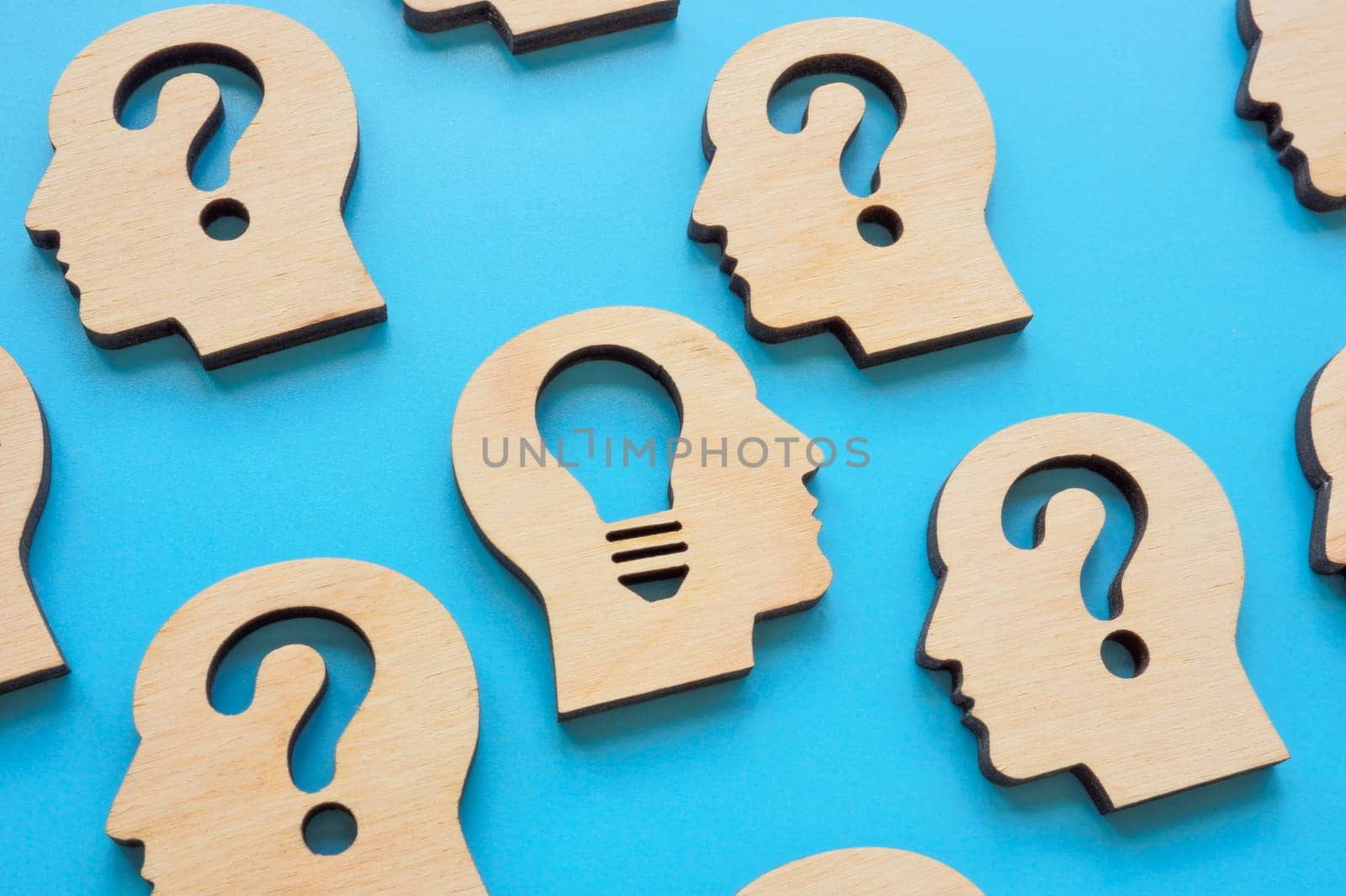 Creative thinking and problem solving. Head with question marks and a light bulb.