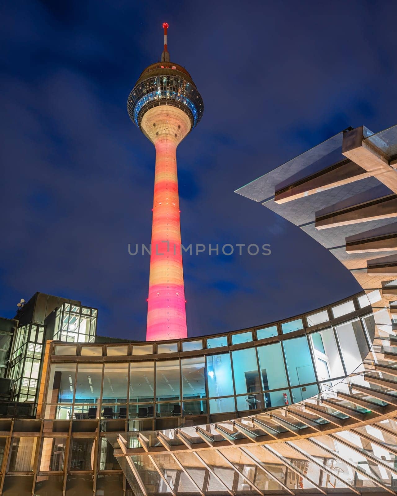 DUSSELDORF, GERMANY - MARCH 25, 2023: Illuminated Rhine Tower and state parliament of North Rhine Westphalia on March 25, 2023 in Dusseldorf, Germany, Europe