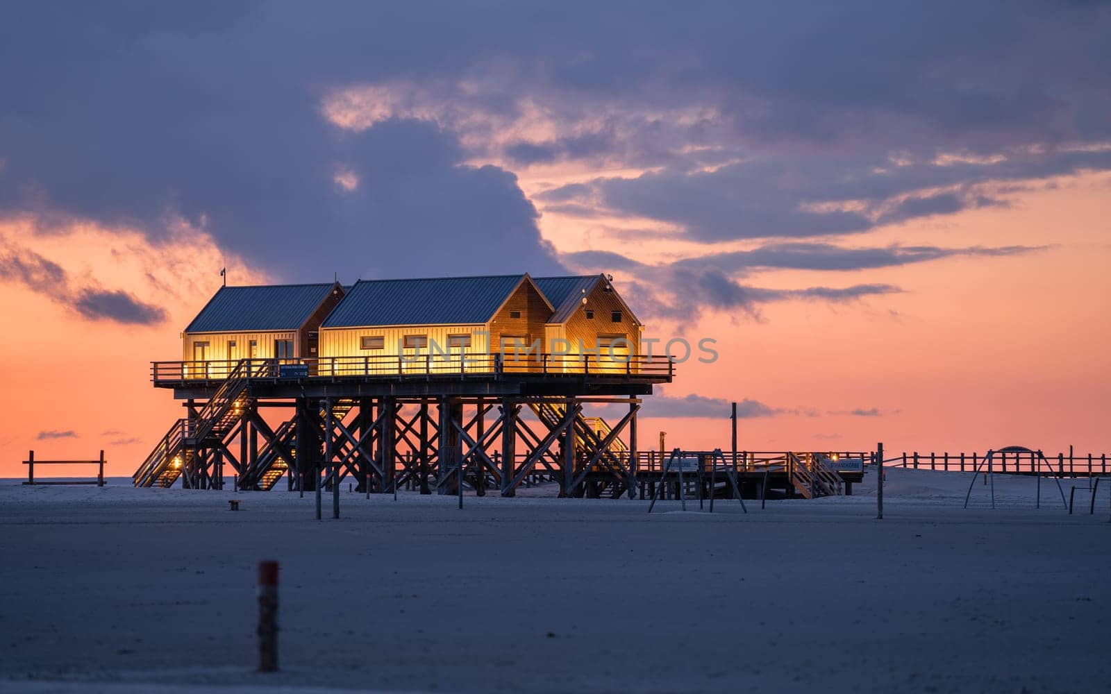 SANKT PETER ORDING, GERMANY - MARCH 8, 2023: Panoramic image of beach houses of Sankt Peter Ording close to the North Sea on March 8, 2023 in North Frisia, Germany