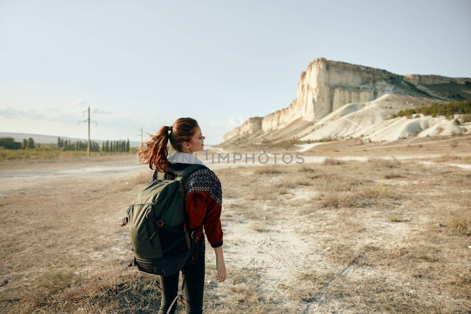 Solitary hiker in desert landscape gazing at majestic mountain peak on the horizon
