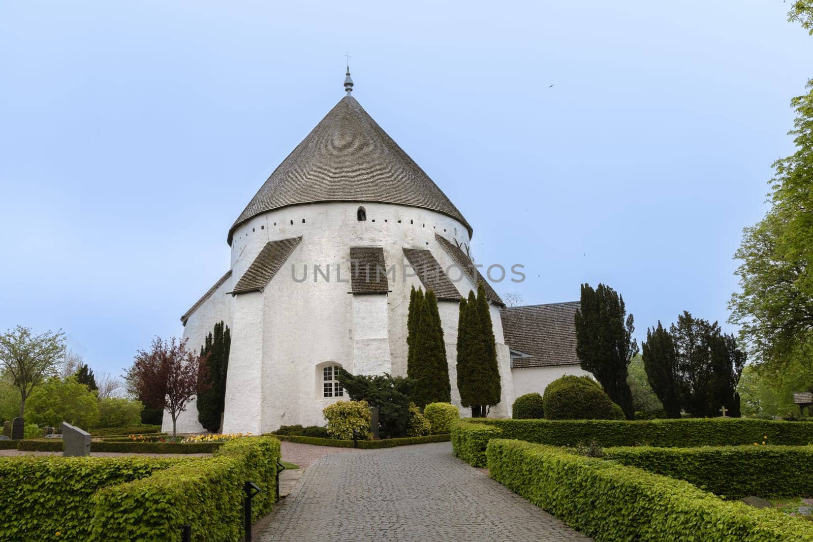 White round Osterlars church on the island of Bornholm. Concept of historical building and landmarks of Denmark.