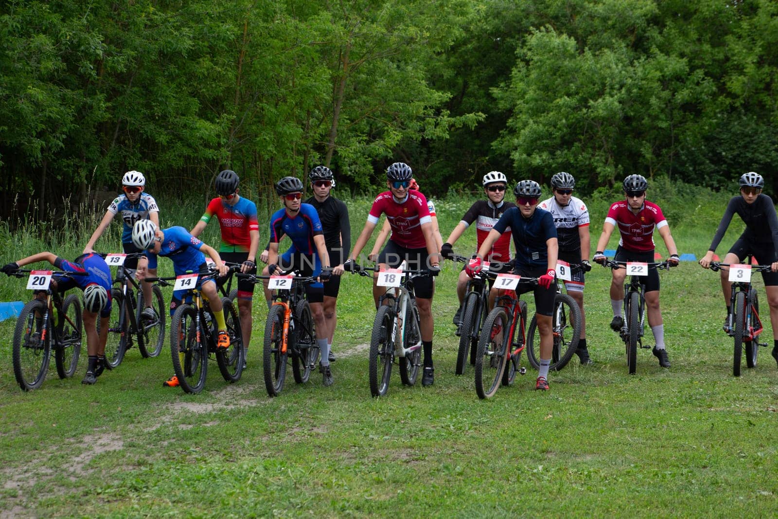 Kursk, Russia, June 15, 2024: Large group of young guys on bicycles are preparing for the start of cross country cycling competition