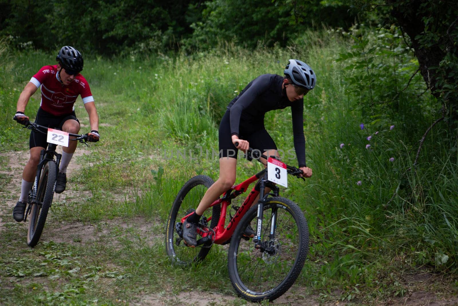 Kursk, Russia, June 15, 2024: Young men on cross-country bicycles ride in competition, mountain bike sport racing