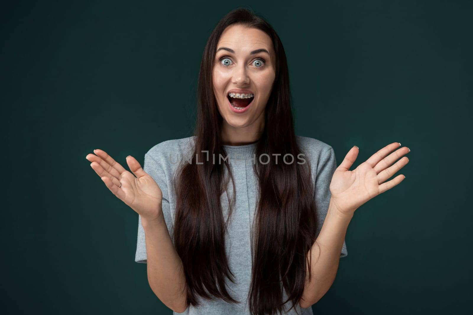 A woman with a surprised look on her face, her eyes wide and mouth slightly agape. She appears startled or amazed by something unexpected. Her eyebrows are raised, and her expression conveys shock or astonishment.