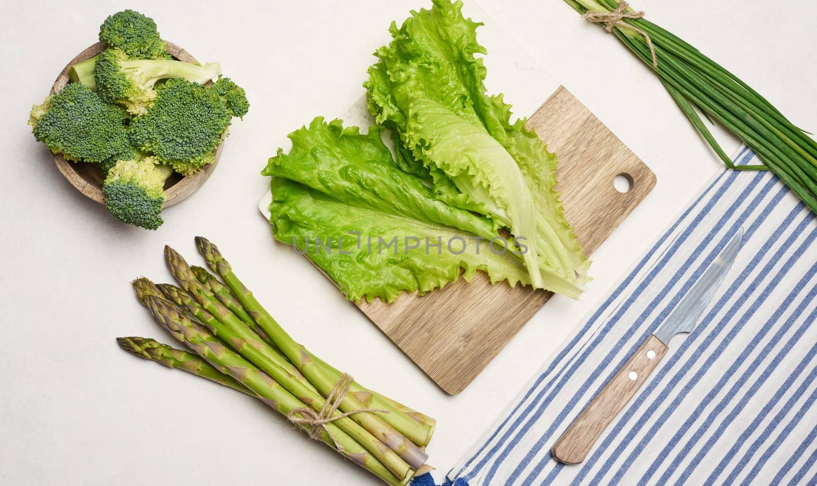 Raw asparagus, broccoli and spices on white background, top view