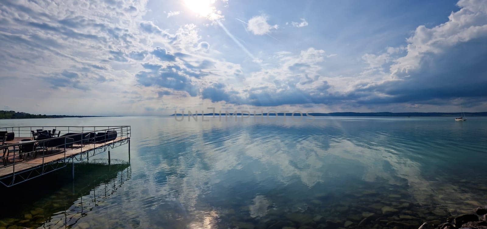 BALATON LAKE/HUNGARY - 2023-05-07 View on a Balaton lake. Great reflection of sky from wather surface.