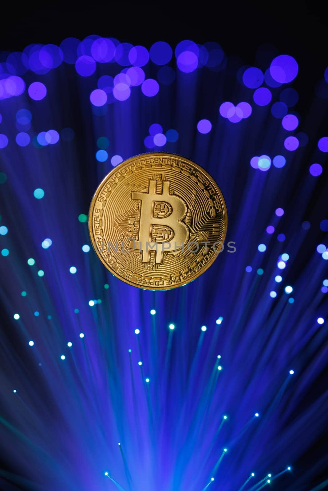 Glowing Bitcoin cryptocurrency against the background of fiber optic cables. Bitcoin digital cryptocurrency consisting of dots and lines, cryptocurrency mining. cryptocurrency exchange