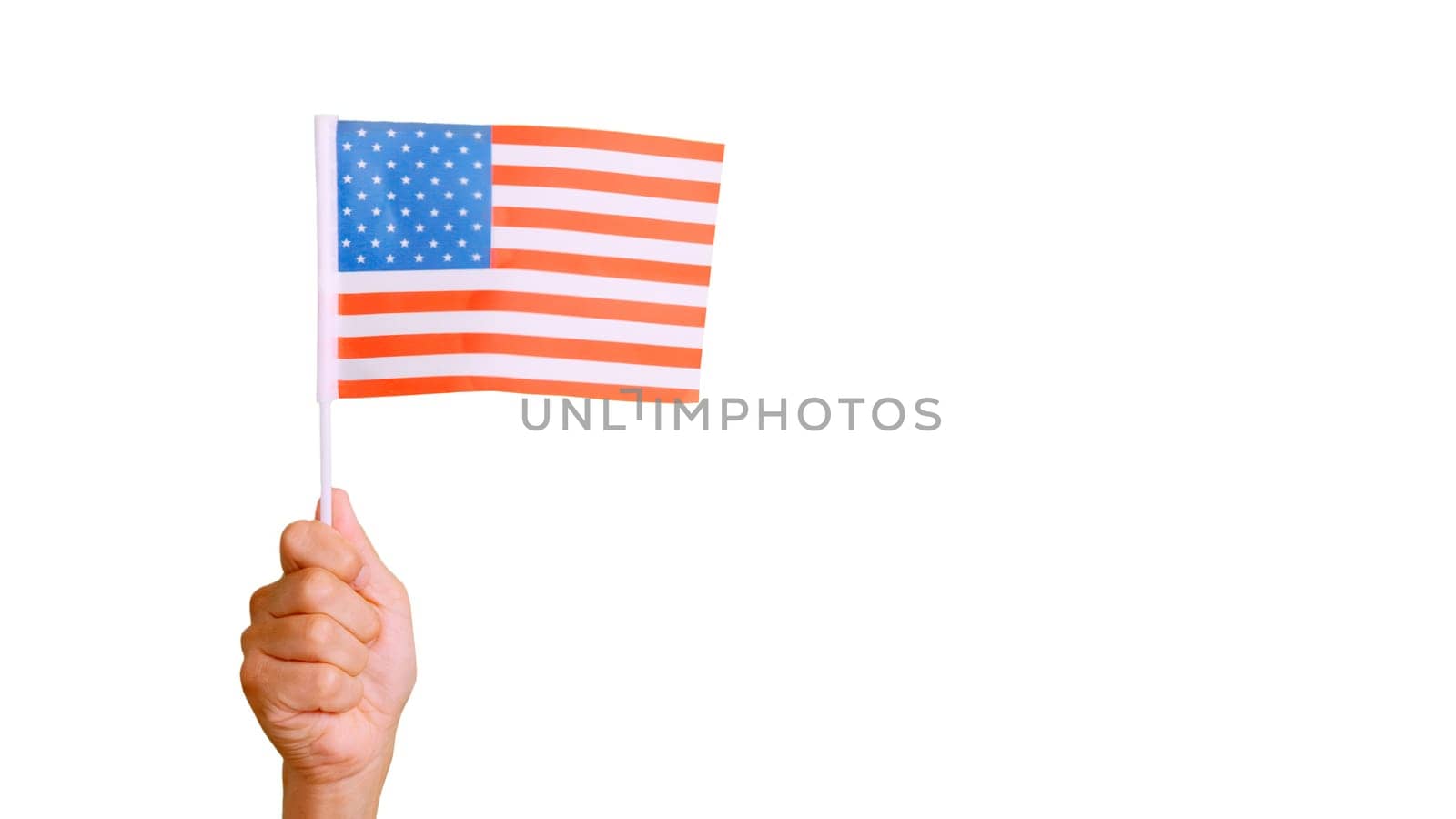 Photo of the wind waving a USA pennant holding by a hand