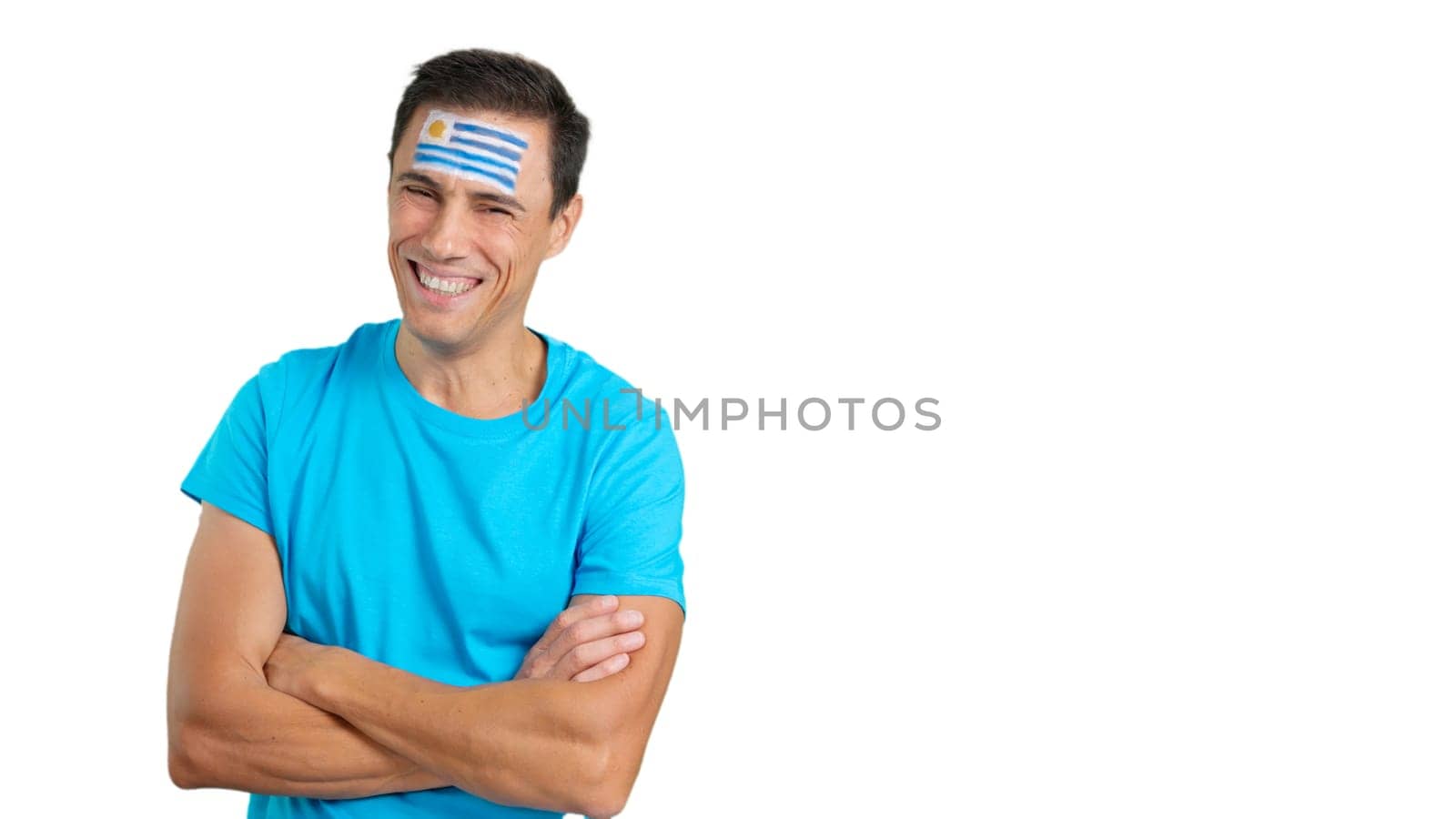 Man standing with uruguayan flag painted on face smiling by ivanmoreno