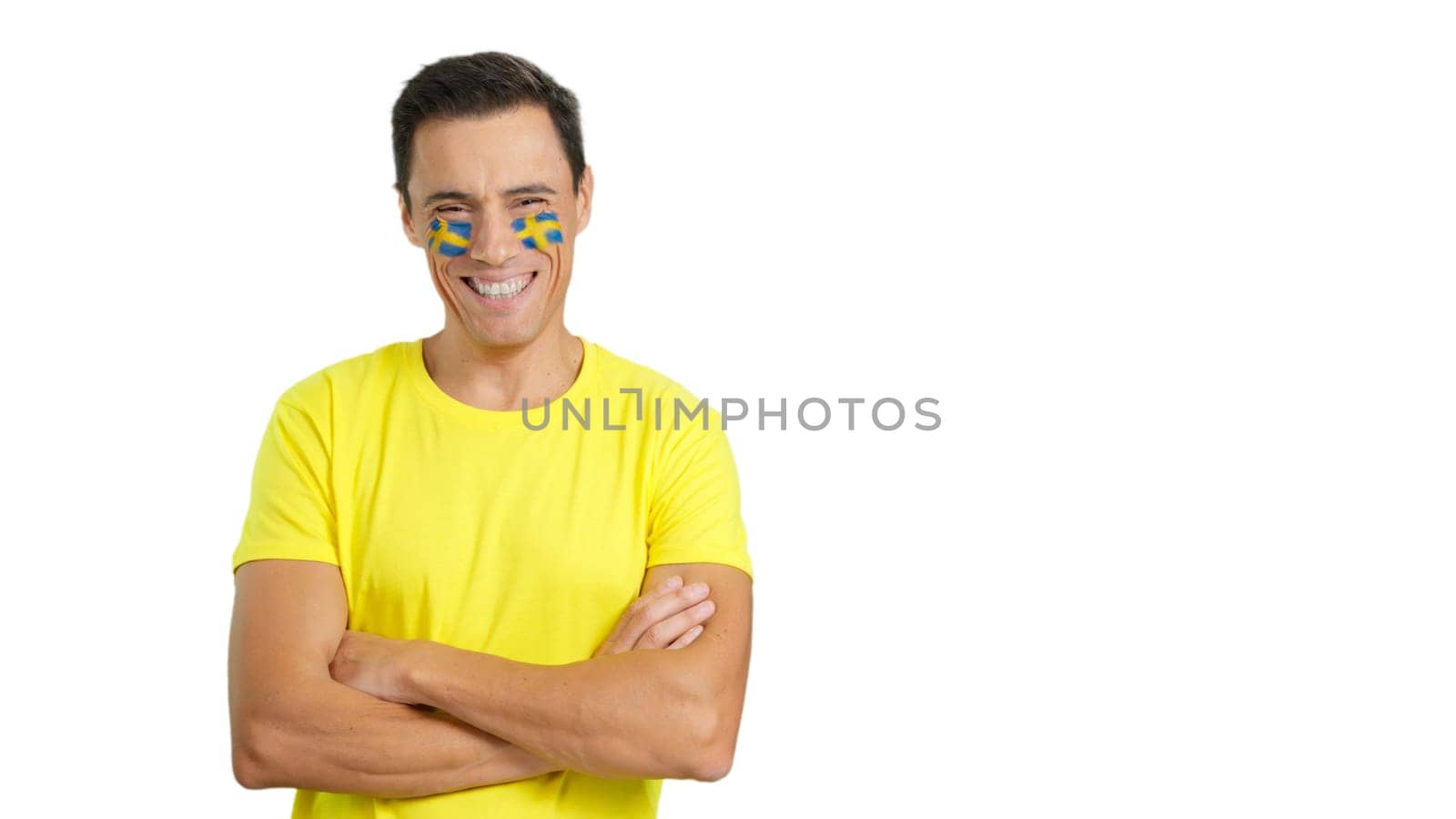 Man standing with swedish flag painted on face smiling by ivanmoreno