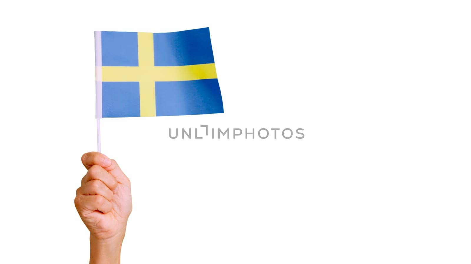 Photo of wind waving a swedish pennant holding by a hand