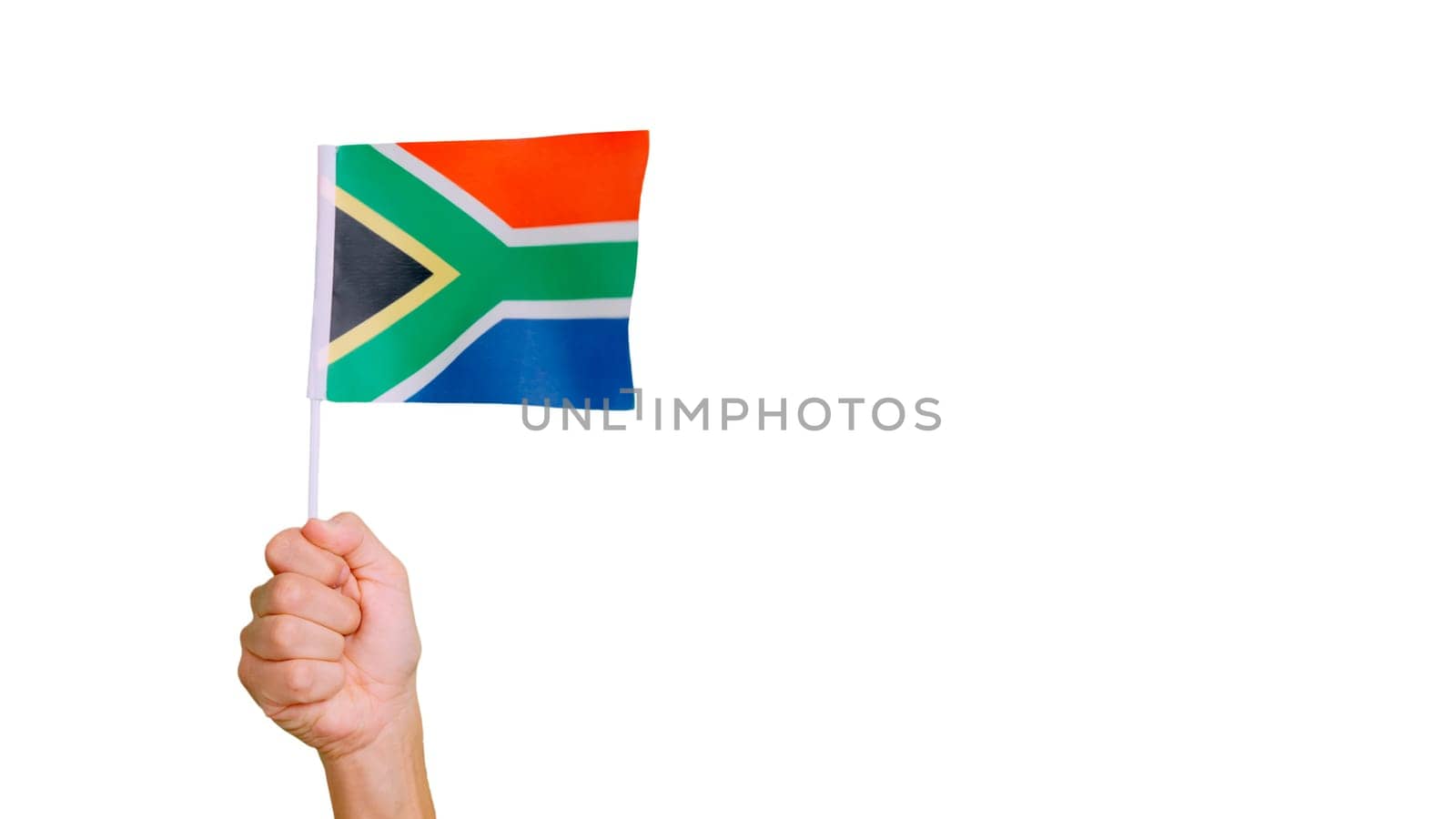 Photo of wind waving a south african pennant holding by a hand