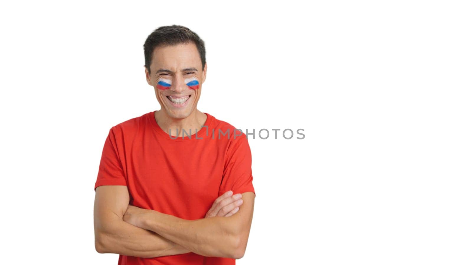 Man standing with russian flag painted on face smiling with arms crossed