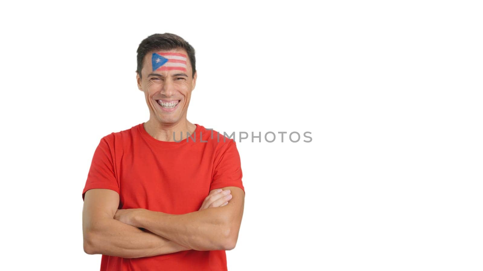 Man standing with puerto rican flag painted on face smiling by ivanmoreno