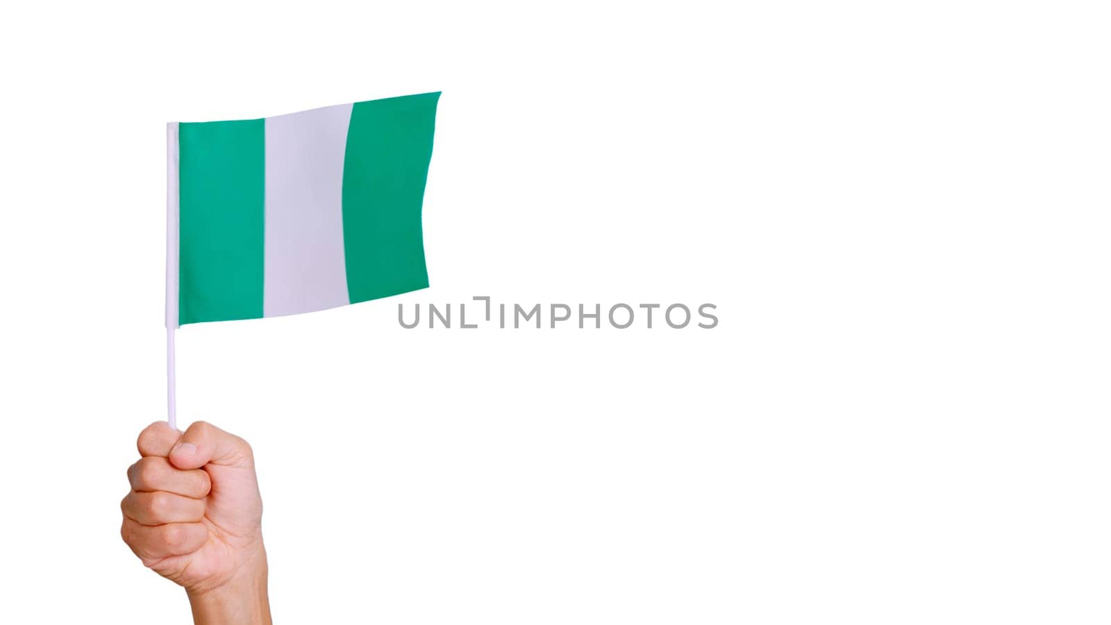Photo of wind waving a nigerian pennant holding by a hand. Slow Motion video