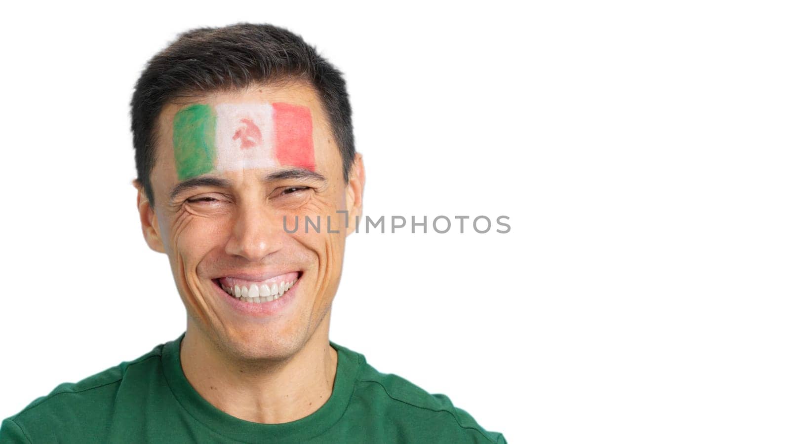 Close up of a man with a mexican flag painted on the face smiling at camera