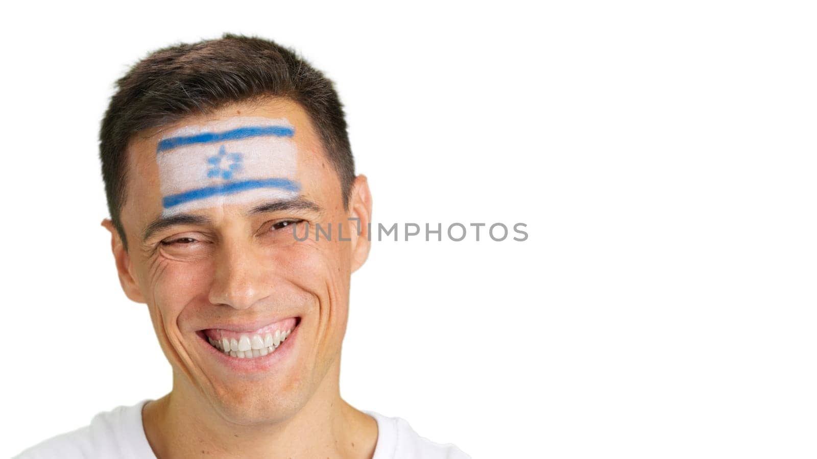 Close up of a man with a israeli flag painted on the face smiling at camera
