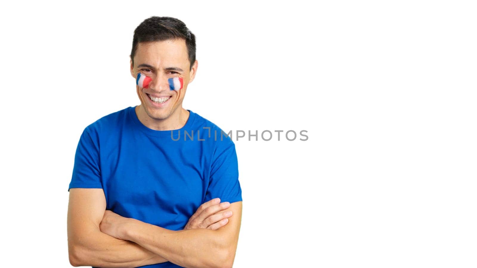 Man standing with french flag painted on face smiling with arms crossed