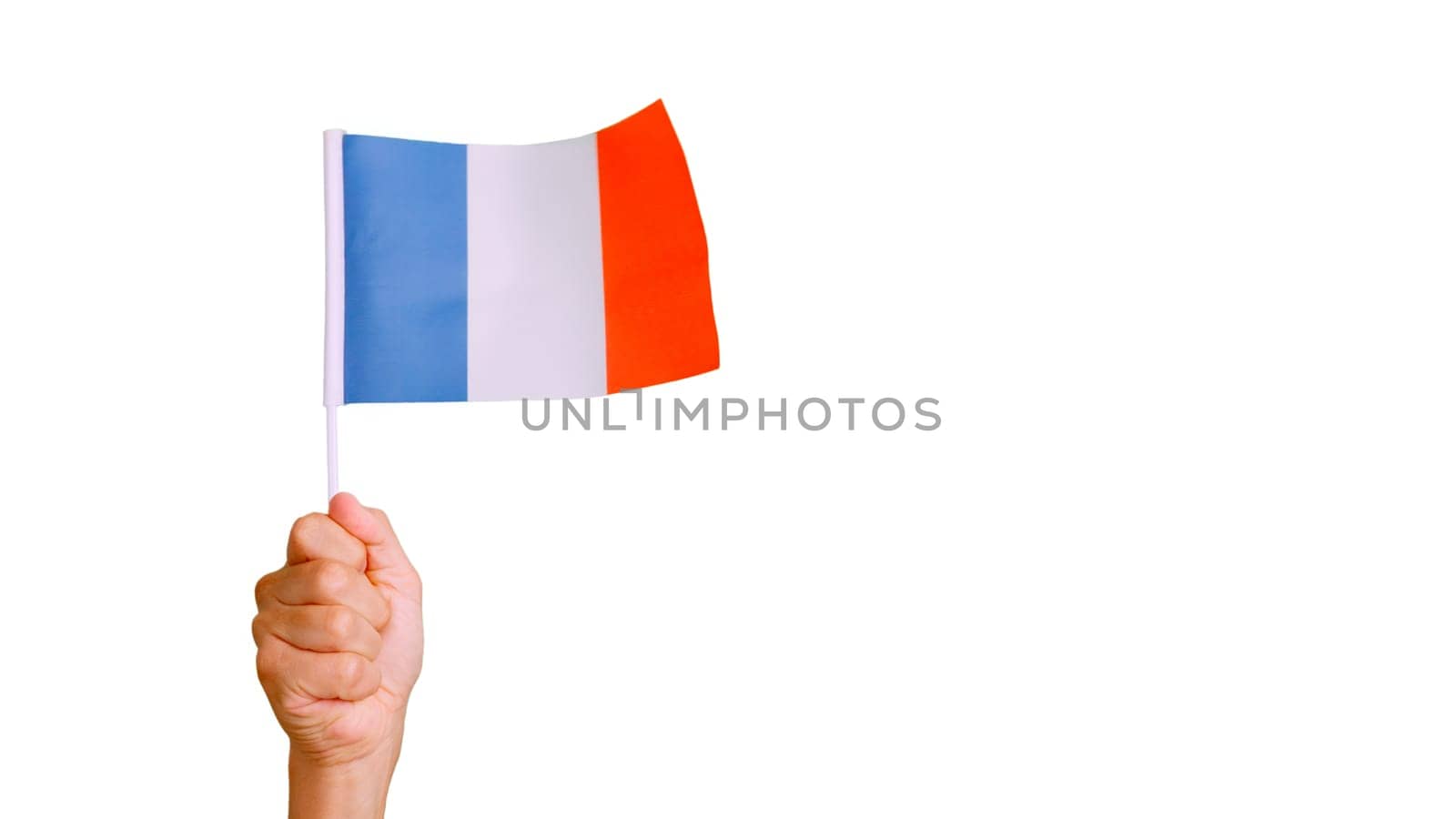 Photo of wind waving a french pennant holding by a hand