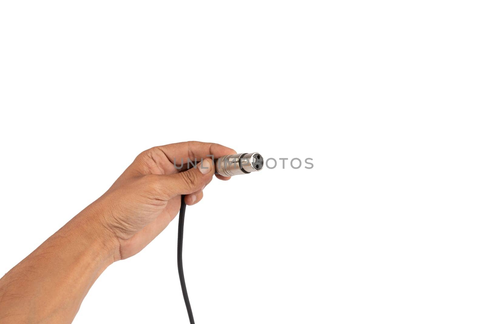 Male hand holding an XLR audio connector cable isolated on white background. High quality photo