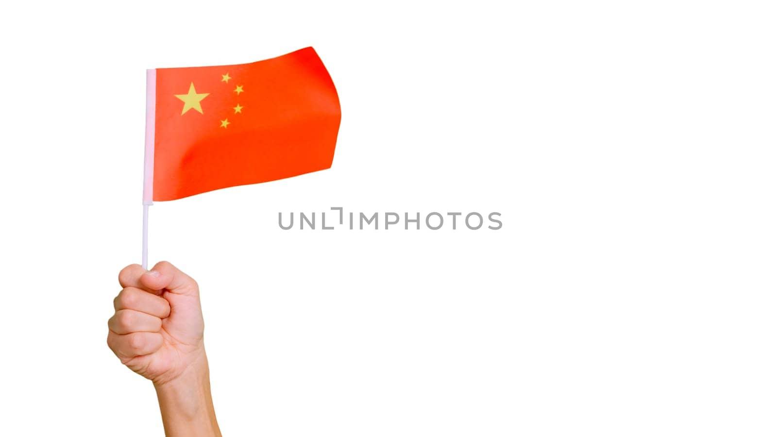 Photo of wind waving a chinese pennant holding by a hand