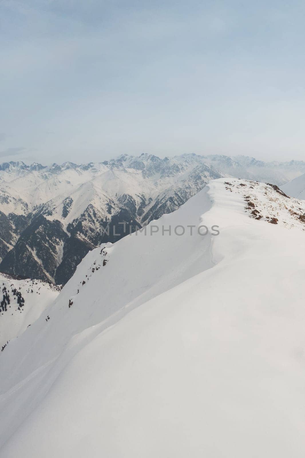 View of winter Tien Shan mountain ranges from Bukreev Peak in the mountains of Central Asia, Kazakhstan - Almaty.