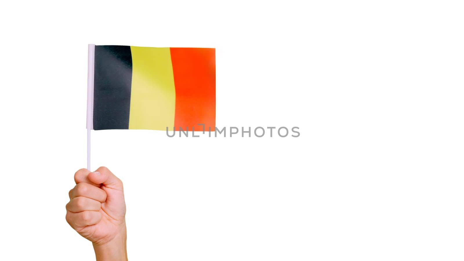 Photo of wind waving a belgian pennant holding by a hand.