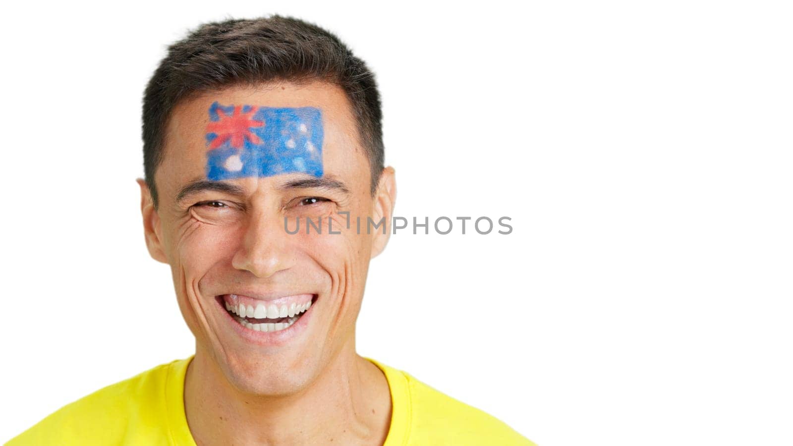 Close up of a man with a australian flag painted on the face smiling at camera