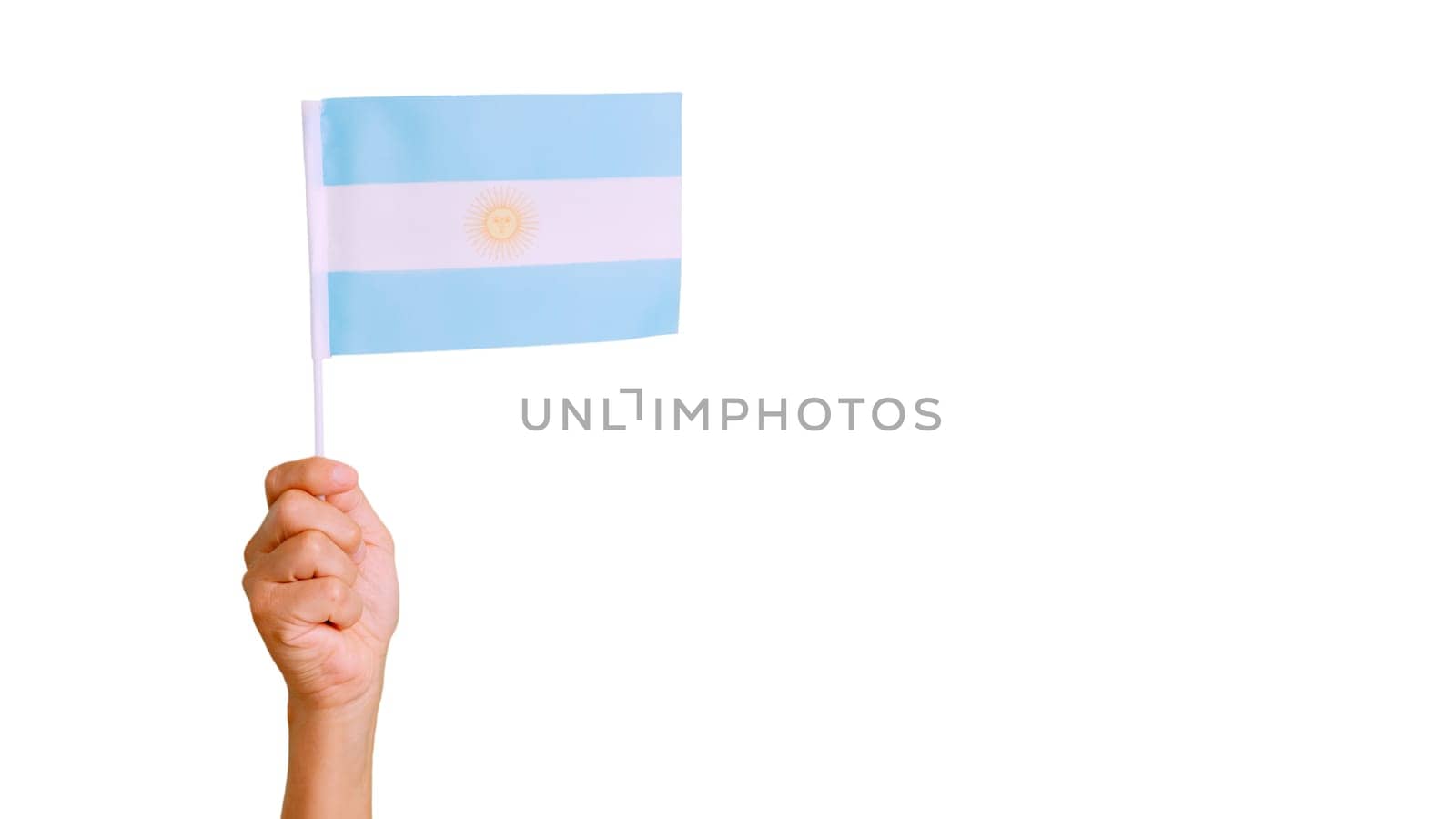Picture of wind waving a argentine pennant holding by a hand