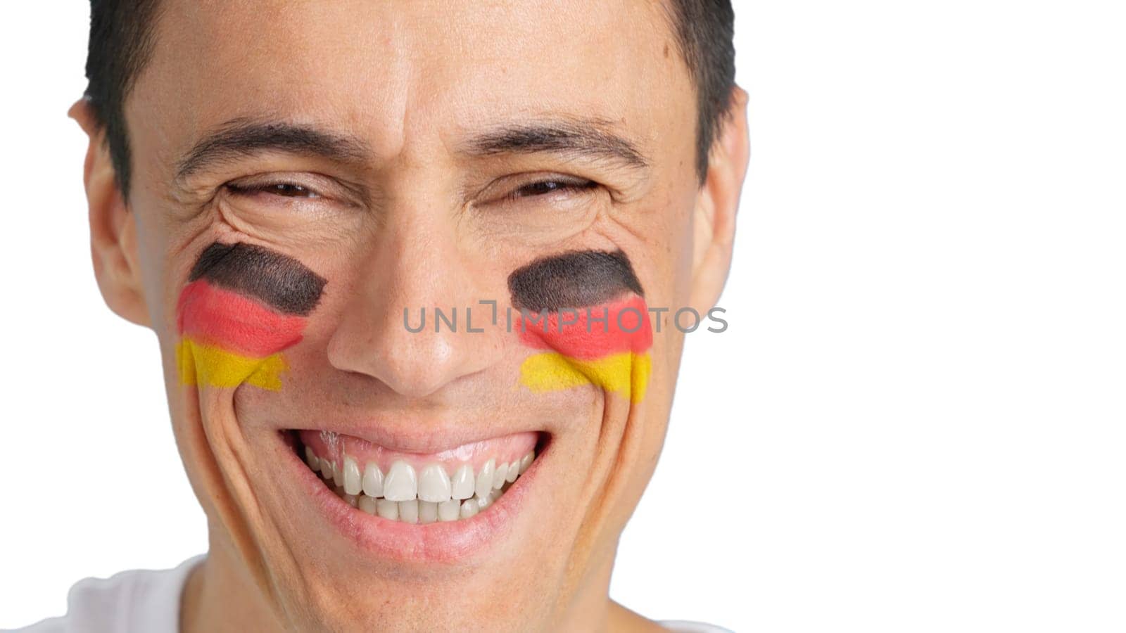 Close-up of a caucasian man with a german flag painted on the face smiling at camera