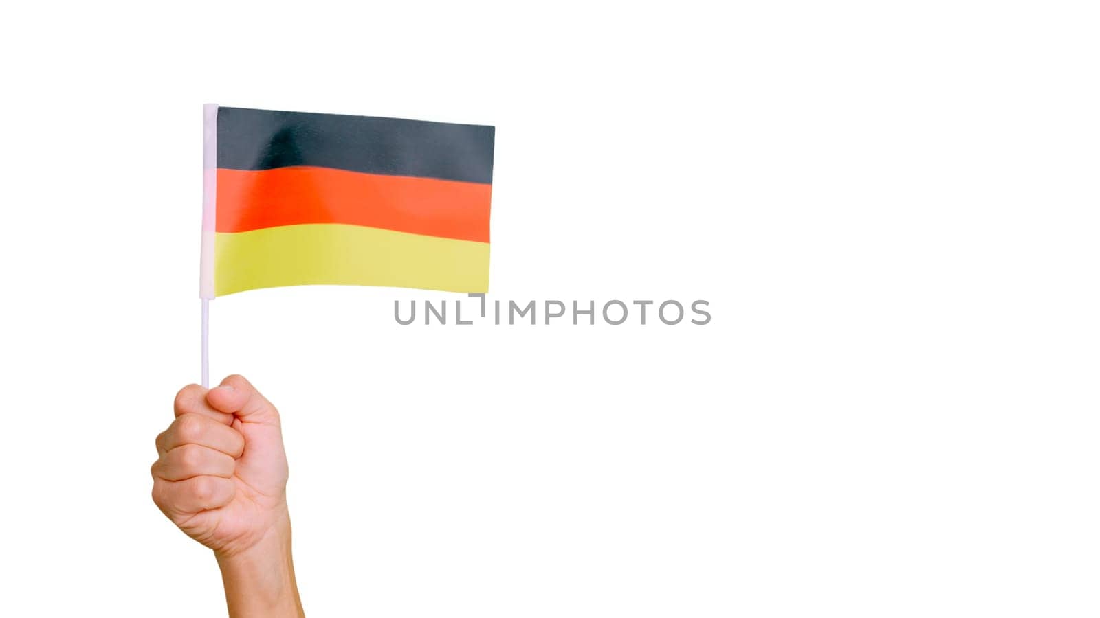 Photo of wind waving a german pennant holding by a hand