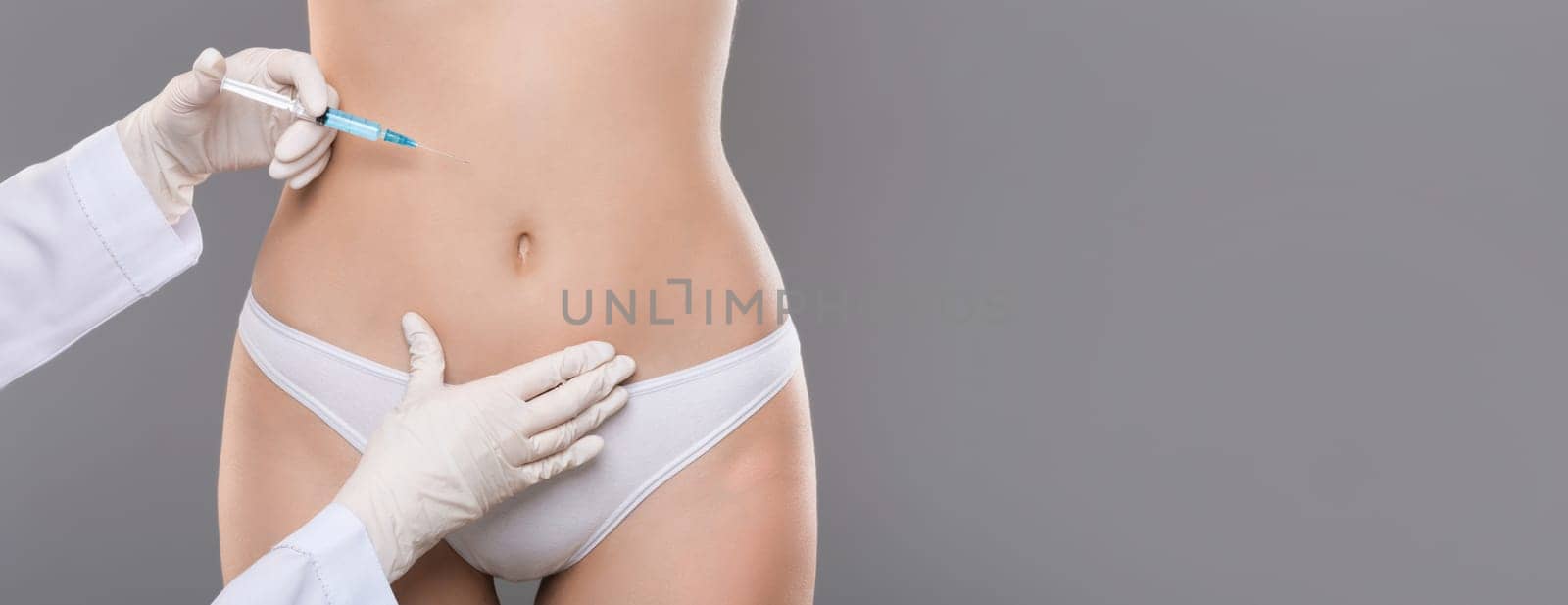 Beauty procedure. Unrecognizable woman having lipolysis treatment at beauty salon, closeup, grey background