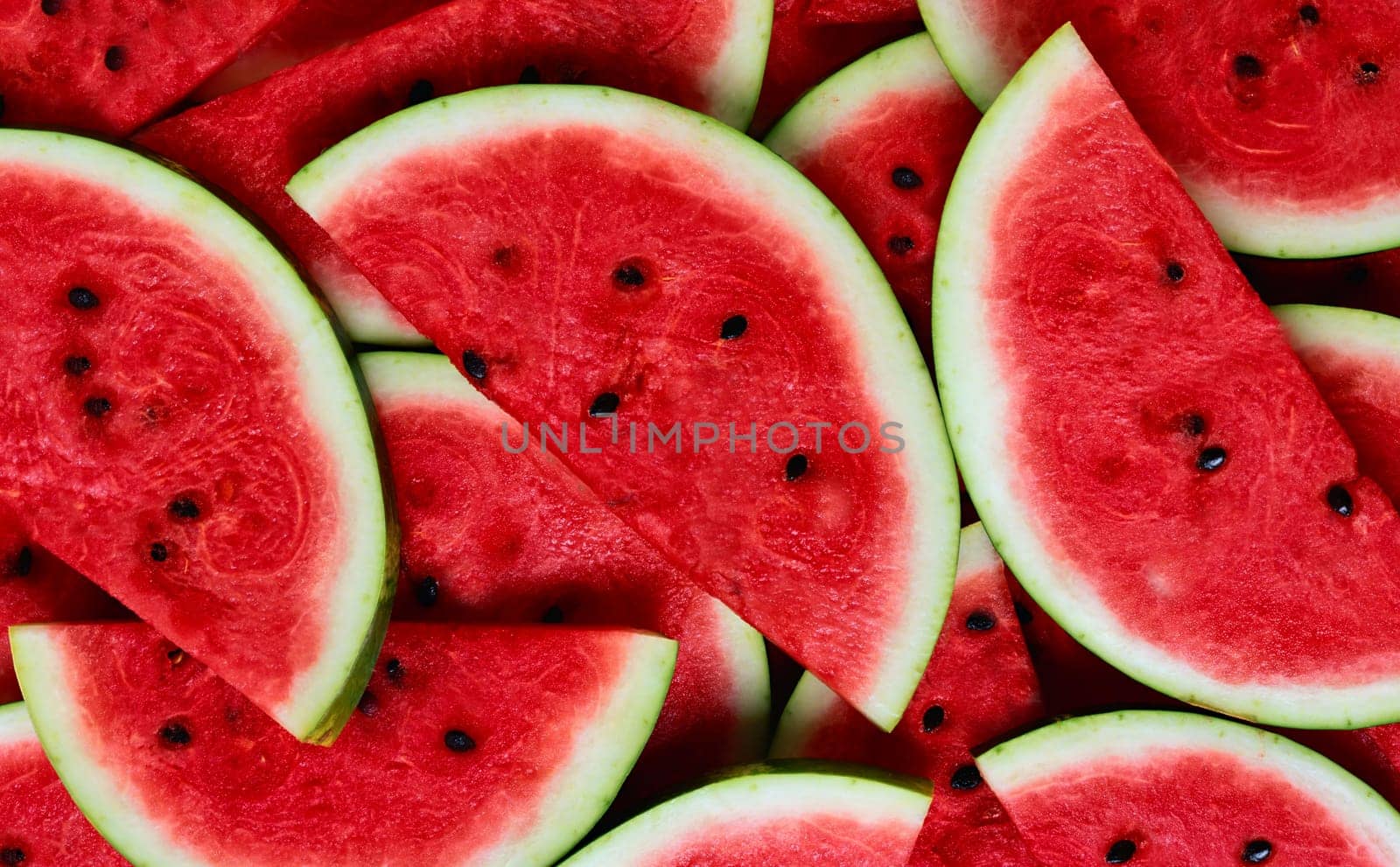 Large ripe juicy bright red watermelon slices close-up view from above