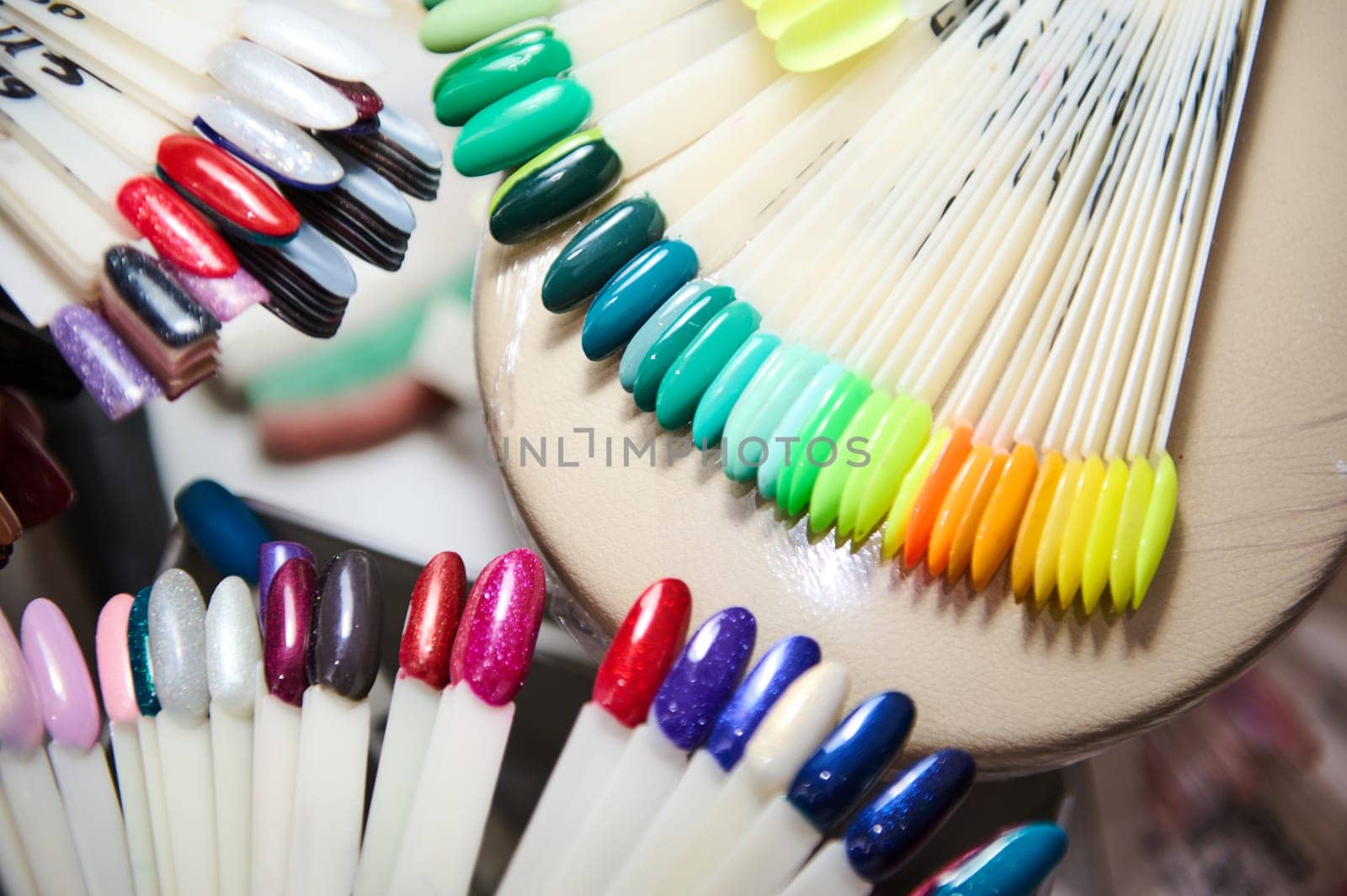 A variety of colorful nail polish samples displayed in a beauty salon, showcasing different shades and finishes.