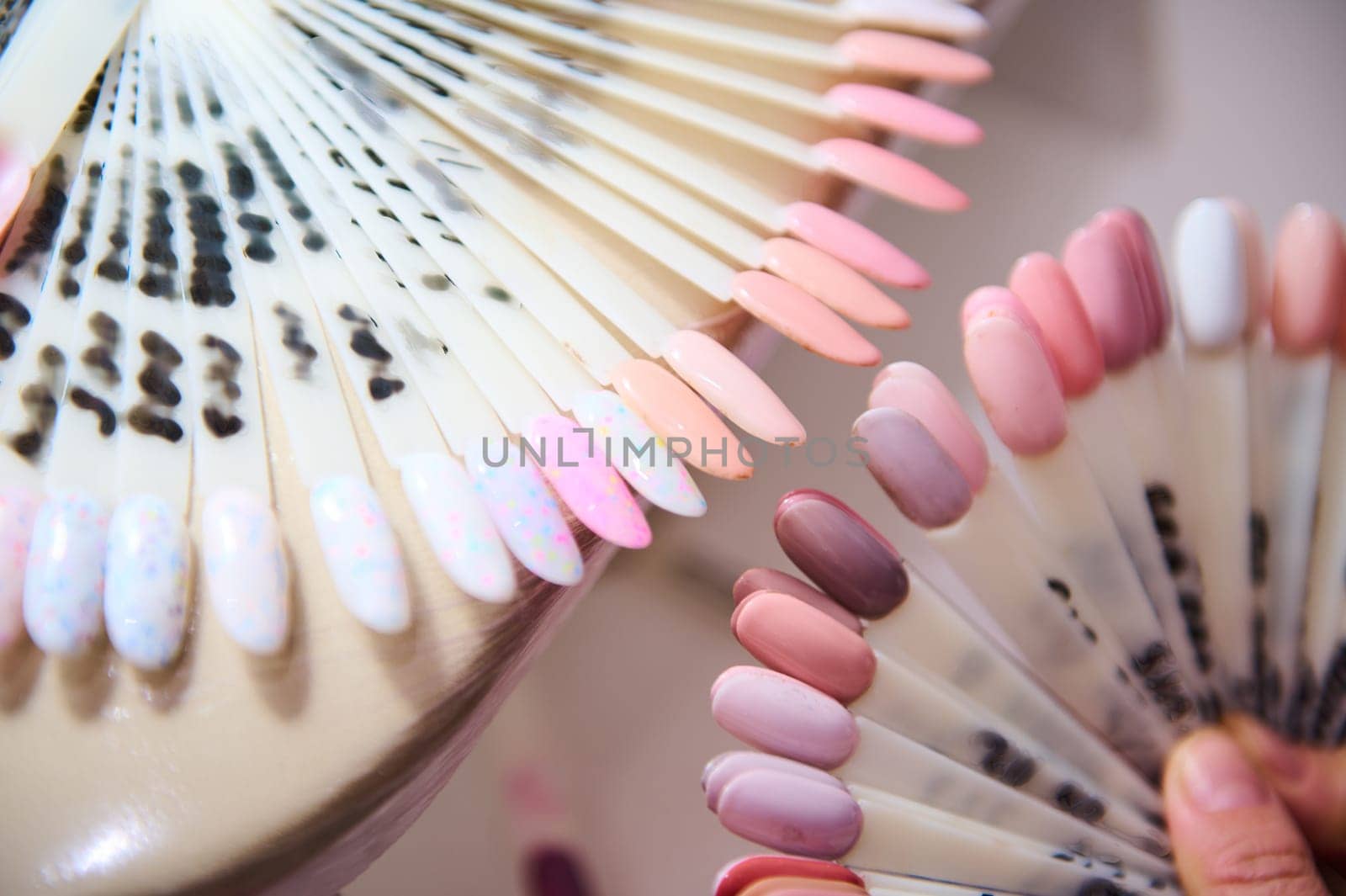 Variety of nail polish samples in different shades displayed at a beauty salon. Perfect for manicure enthusiasts.