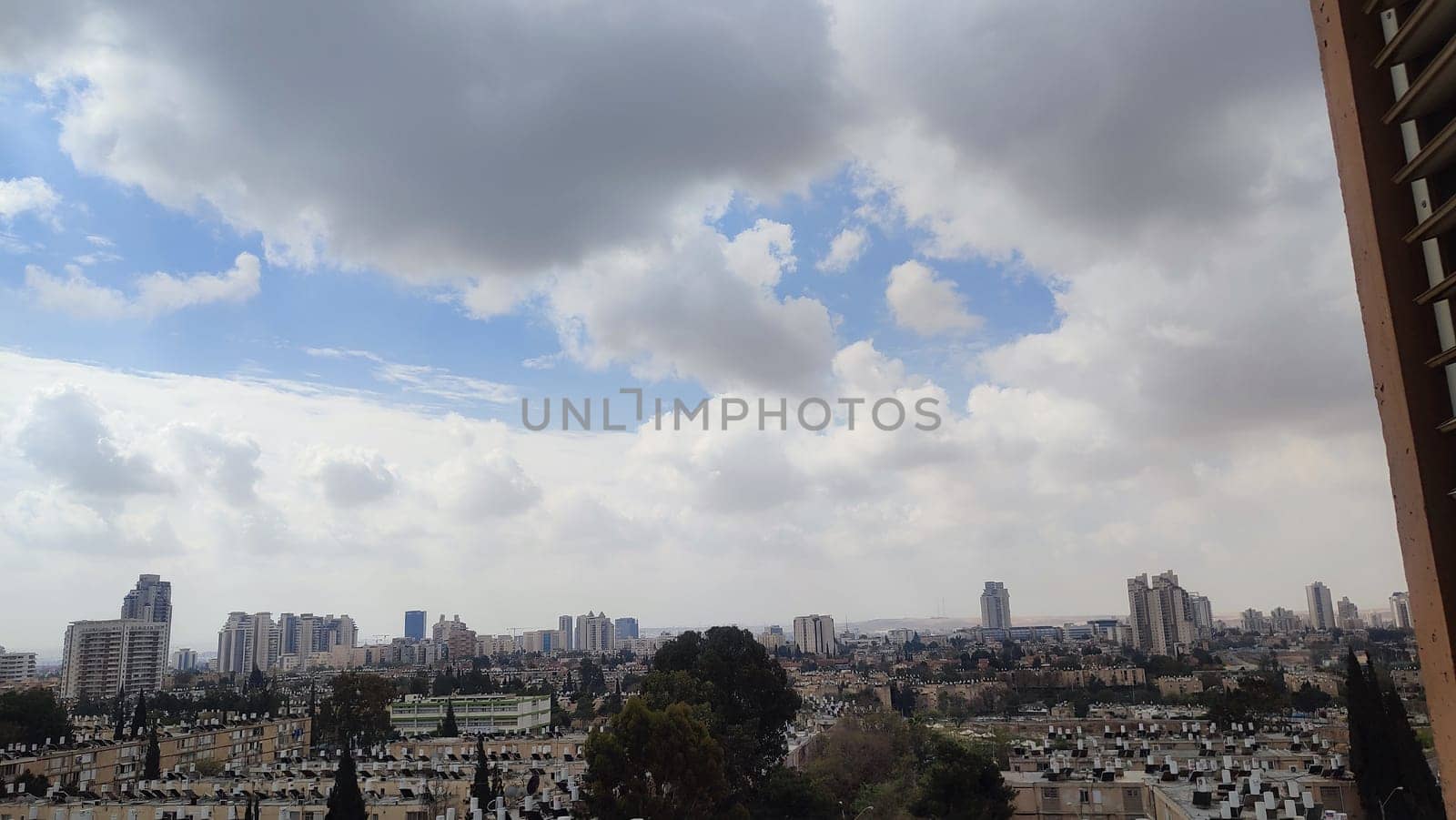 view of the city and buildings from the window, landscape sky clouds. High quality photo