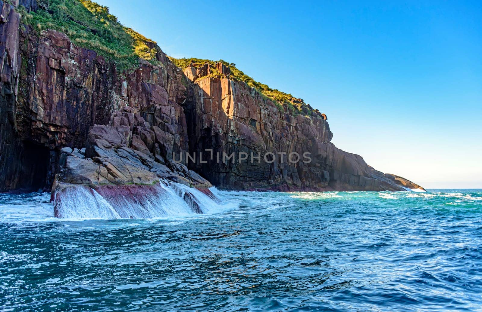 Cliff over the sea waters on the island of Ilhabela in Sao Paulo