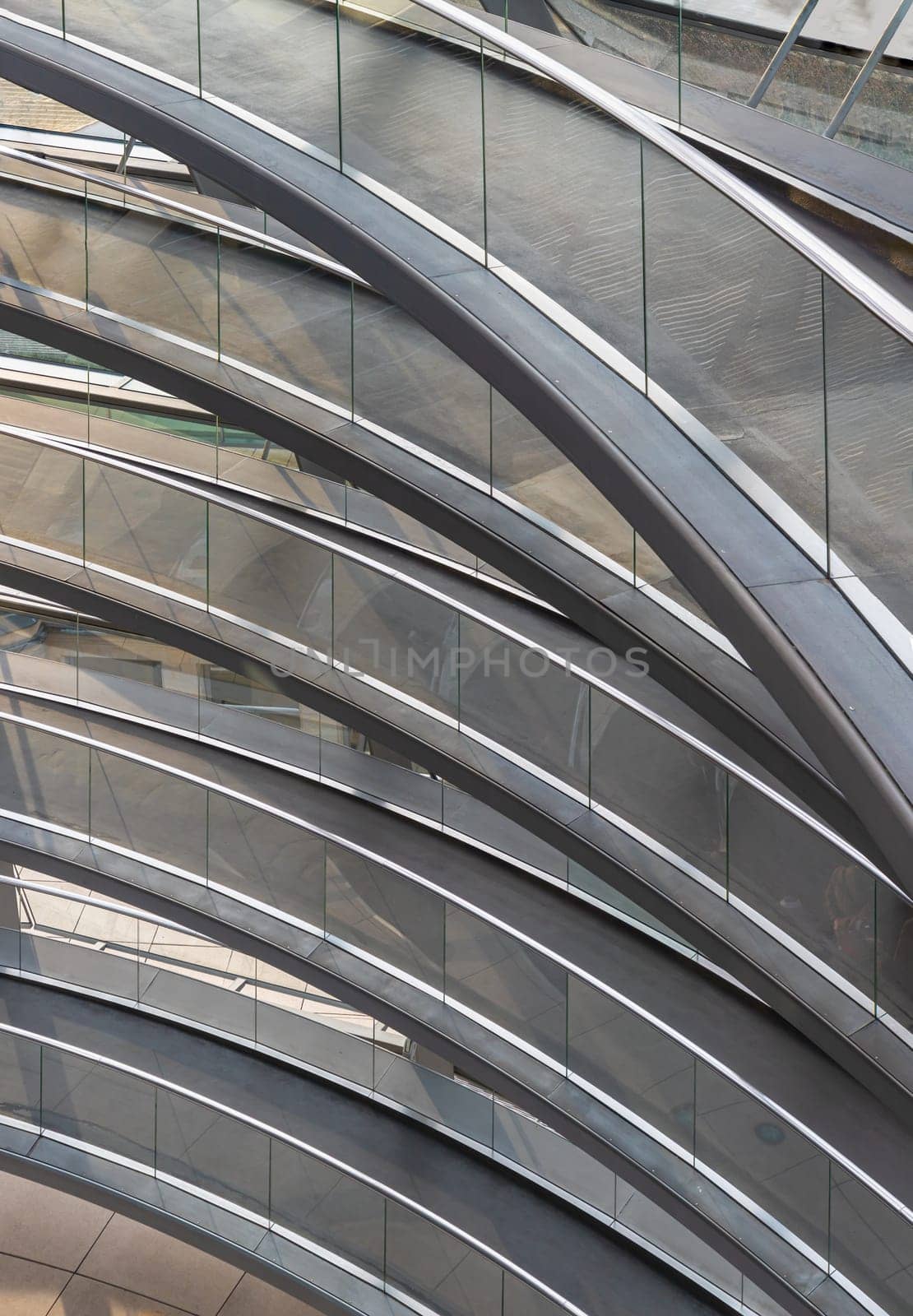 Berlin, Germany - Dec 20, 2023 - A curved walkway stretches in spirals upwards on top inside the glass dome constructed of the Reichstag building. Contemporary architecture of the Cupola of the Reichstag dome, a major tourist attraction of the berlin city, Copy space, Selective focus.