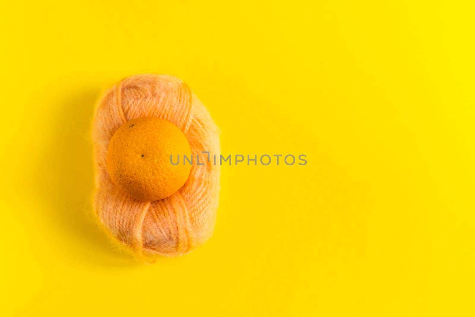 Oranges and tangerines on a yellow background. Fresh healthy food. Chinese New Year