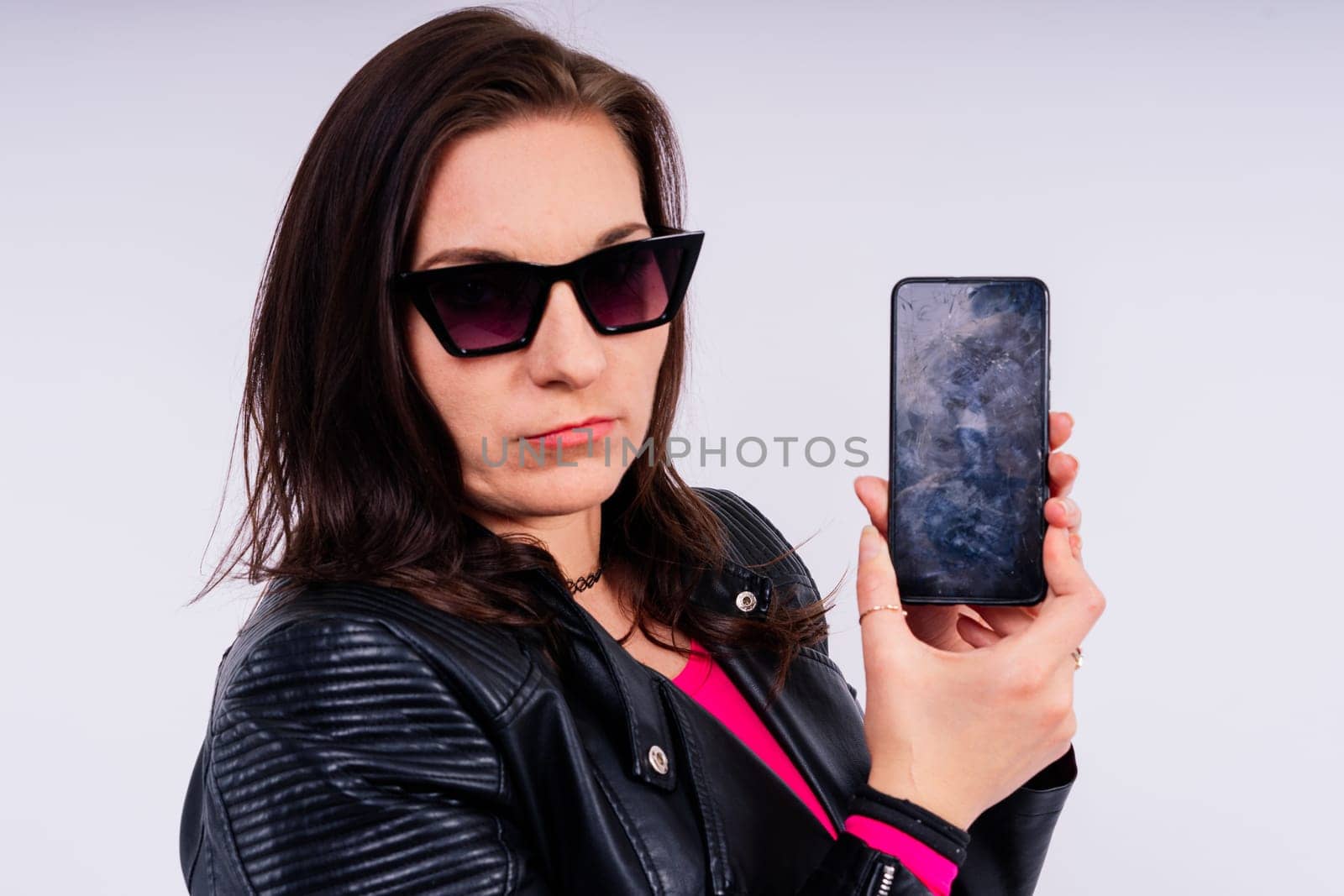 Portrait of a pretty sad woman holding smartphone with broken screen by Zelenin