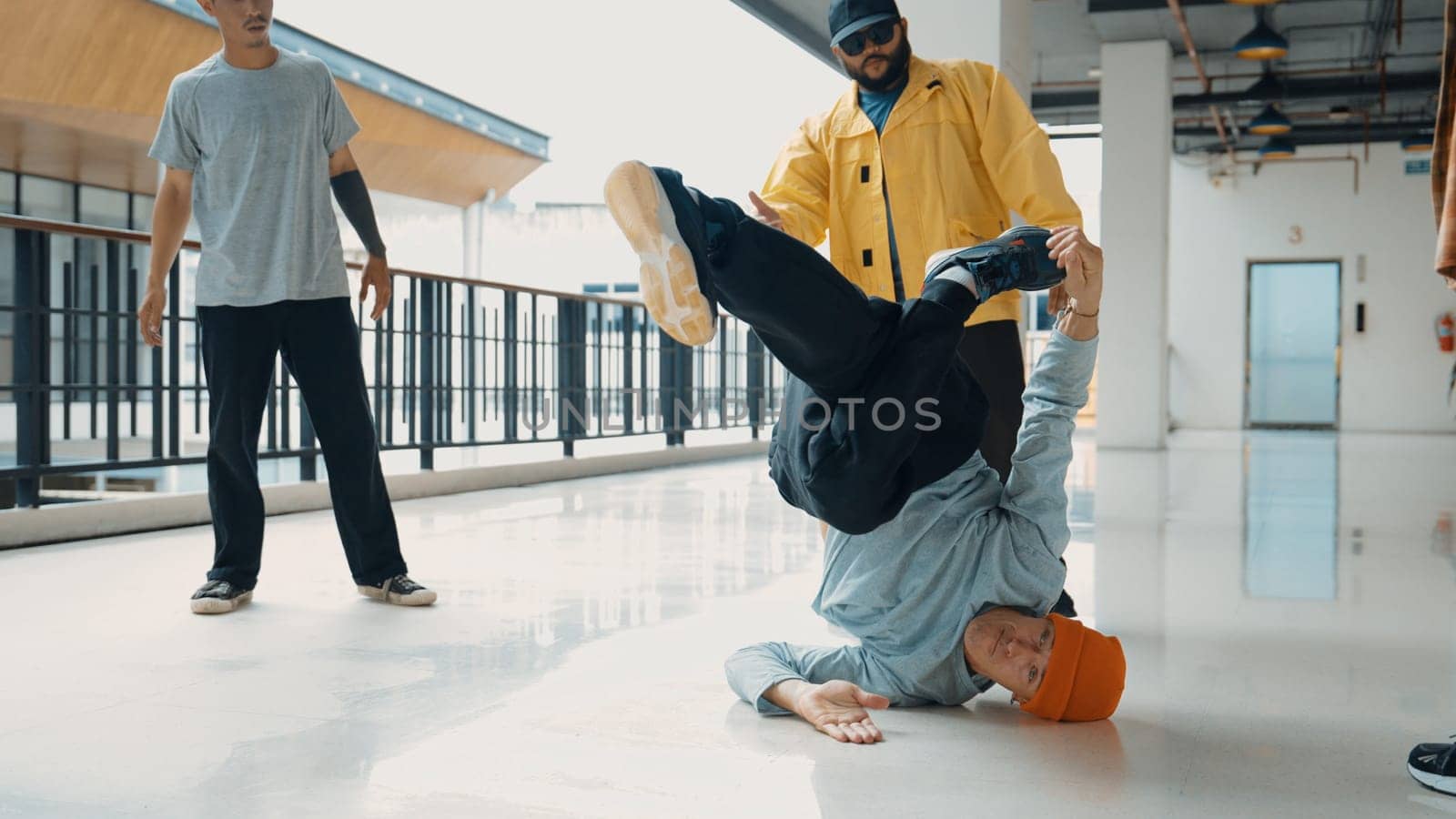 Hip hop team dance break dance while multicultural friend surrounded and clapping hands to cheer or encourage his friend to dance. Active and energetic street dance. Outdoor sport 2024. Endeavor.