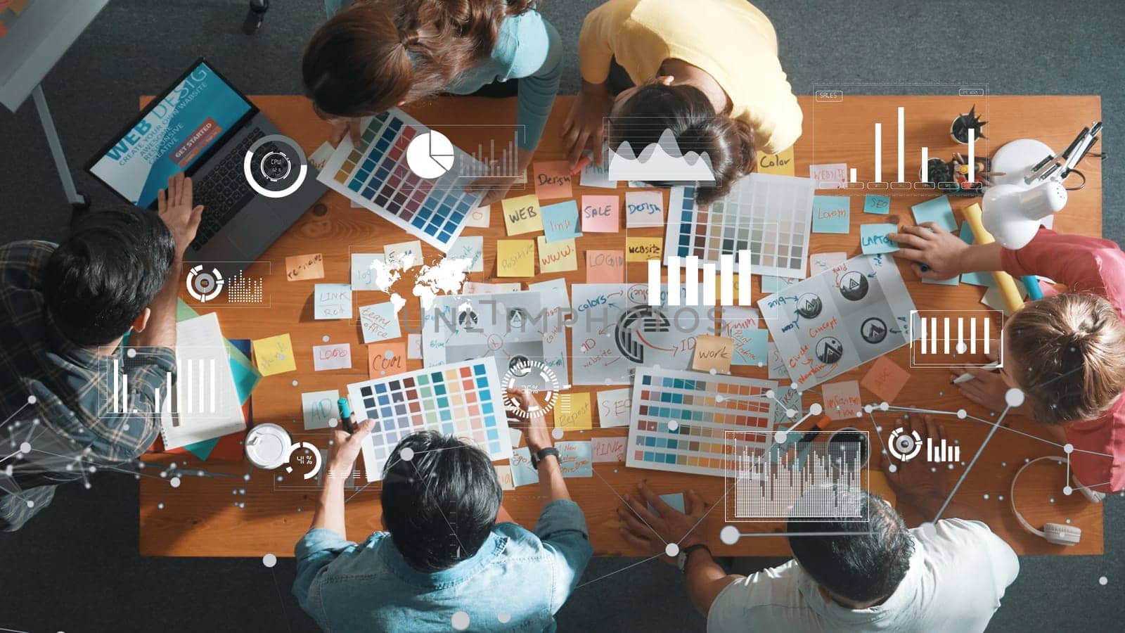 Top down view of business team with casual outfit looking laptop screen and sharing idea. Aerial view of manager works and checking color palette at table with statistic graph holographic. Symposium.