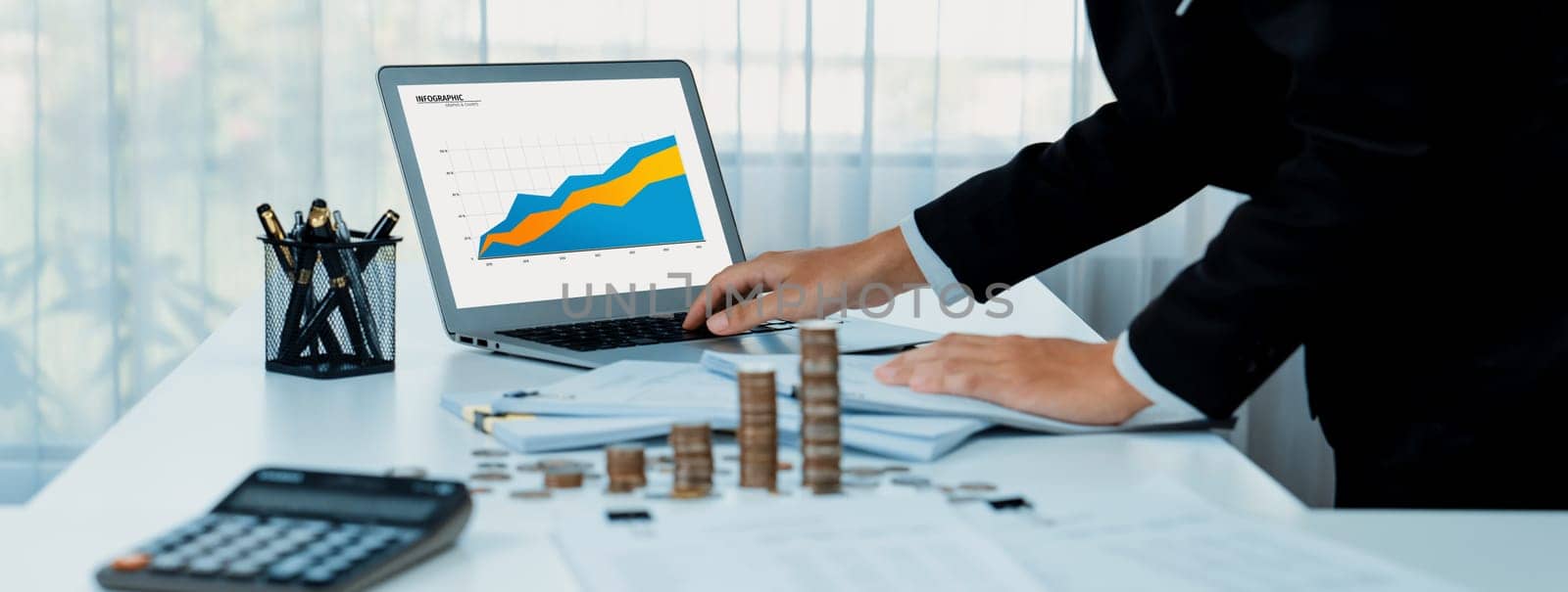 Business intelligence analyst use BI software on laptop to analyze financial data dashboard with growth stack coin symbolize business technology make investment decision in panorama. Shrewd